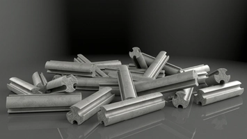 Scattered metallic cylindrical catalyst pellets with cross-shaped profiles on a dark reflective surface